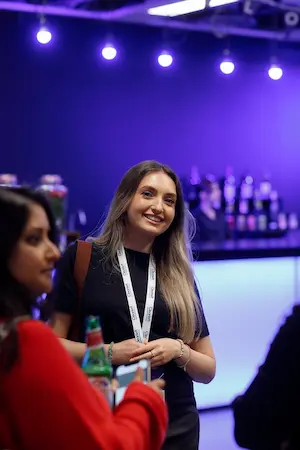 An attendee smiling as she chats during a break.